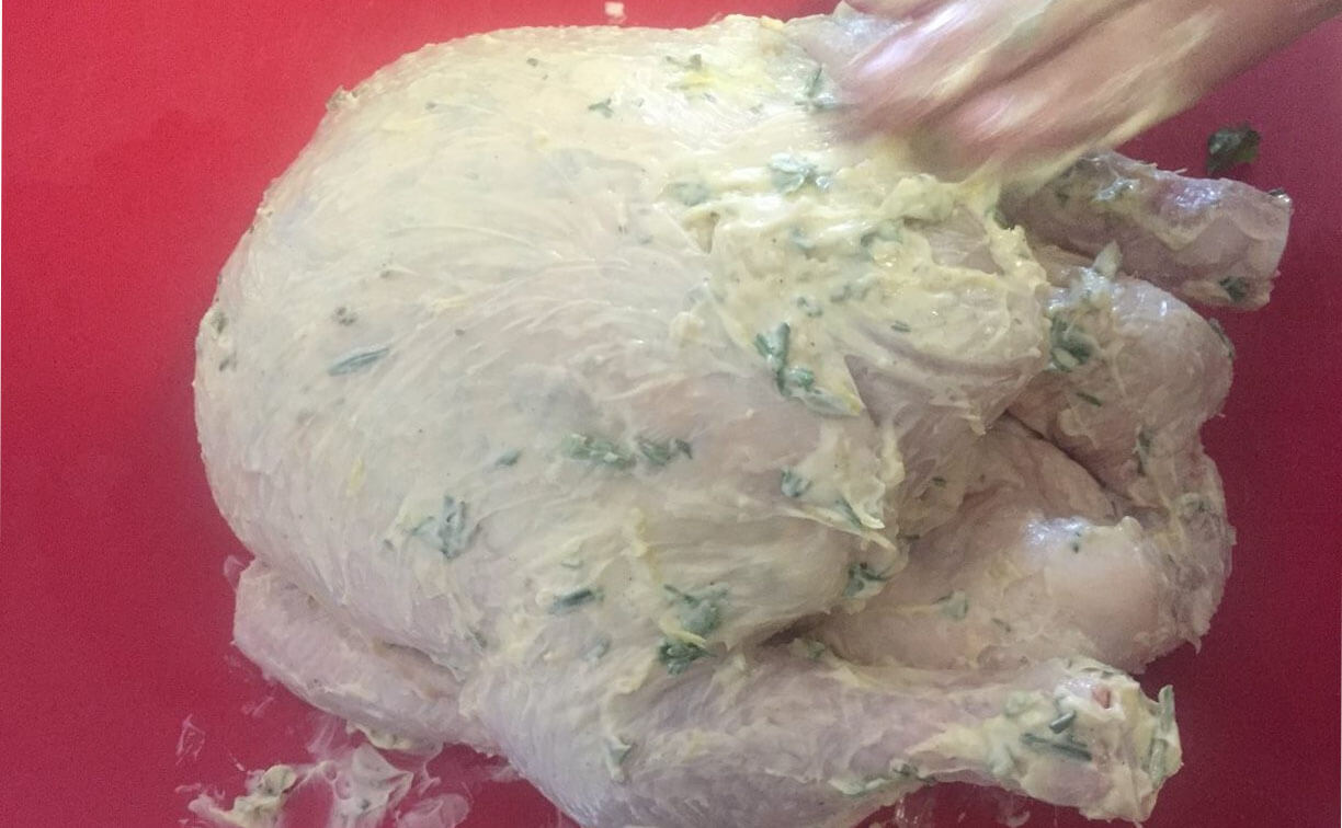 rub the remaining butter on the camp oven roast chicken