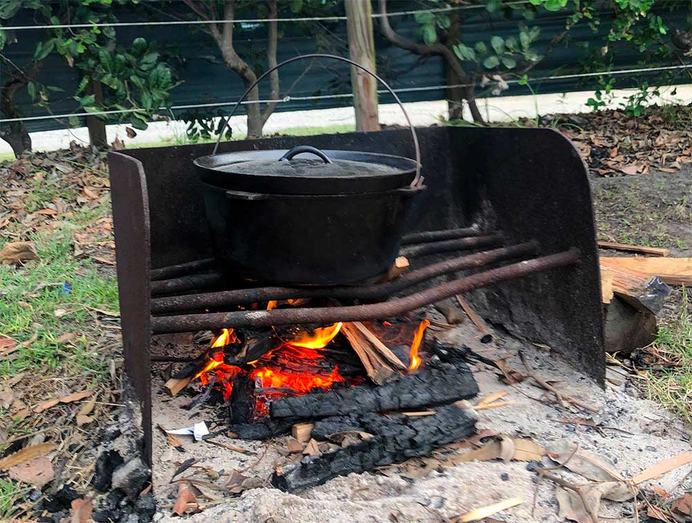 a camp oven over a fire cooking camp oven vegetable stew